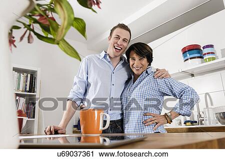 Mother and son looking down at camera View Large Photo Image Stock Image - Mother and son looking down at camera. Fotosearch