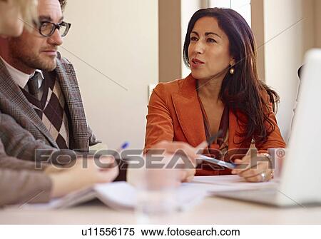 Stock Photography - Office colleagues in meeting. Fotosearch