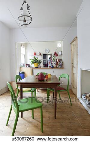 Stock Image - Open plan kitchen diner with table and chairs. Fotosearch