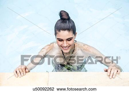 Overhead view of young woman in swimming pool View Large Photo Image Stock Image - Overhead view of young woman in swimming pool. Fotosearch