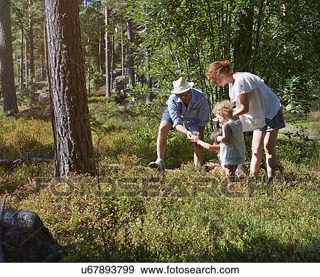 Parents and daughters exploring in forest View Large Photo Image Stock Photo - Parents and daughters exploring in forest. Fotosearch