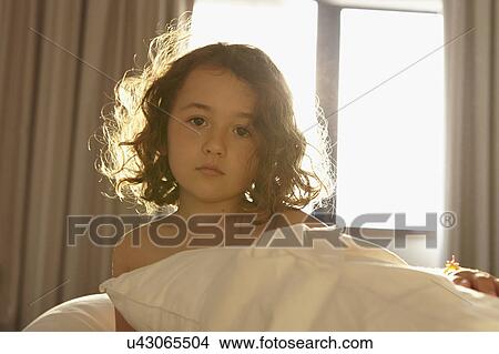 Pensive girl on bed View Large Photo Image Picture - Pensive girl on bed. Fotosearch
