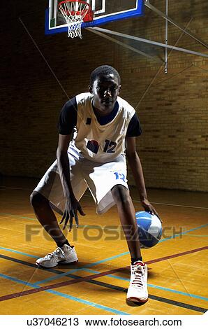 Portrait of basketball player bouncing ball View Large Photo Image Stock Image - Portrait of basketball player bouncing ball. Fotosearch