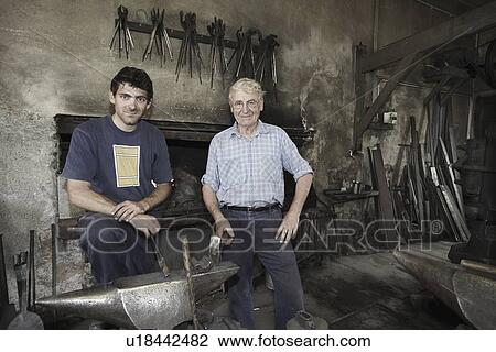 Stock Image - Portrait of blacksmiths in workshop. Fotosearch