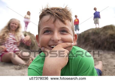 Portrait of boy with hand on chin smiling, Wales, UK View Large Photo Image Stock Photograph - Portrait of boy with hand on chin smiling, Wales, UK. Fotosearch