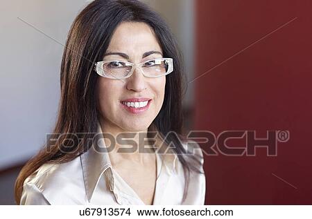 Portrait of brunette businesswoman wearing glasses View Large Photo Image Picture - Portrait of brunette businesswoman wearing glasses. Fotosearch