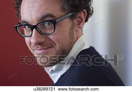 Stock Image - Portrait of businessman wearing glasses. Fotosearch
