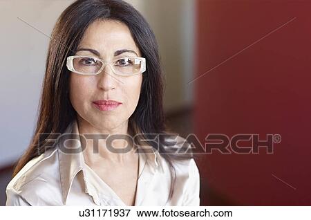 Stock Photo - Portrait of businesswoman wearing glasses. Fotosearch