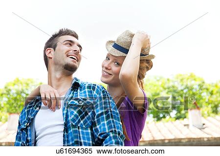Stock Photography - Portrait of couple, woman wearing straw hat. Fotosearch