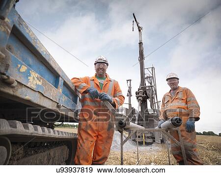 Portrait of drilling rig workers in hard hats and workwear View Large Photo Image Stock Photo - Portrait of drilling rig workers in hard hats and workwear. Fotosearch