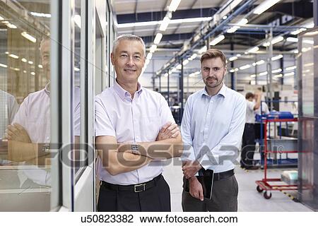 Stock Image - Portrait of engineers in engineering factory. Fotosearch