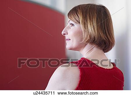 Portrait of female office worker looking away View Large Photo Image Stock Image - Portrait of female office worker looking away. Fotosearch