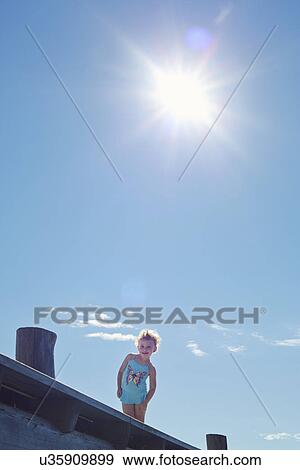 Stock Photo - Portrait of female toddler on pier, Utvalnas, Gavle, Sweden. Fotosearch