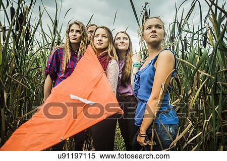 Portrait of five young women in marshes holding kite View Large Photo Image Stock Photography - Portrait of five young women in marshes holding kite. Fotosearch