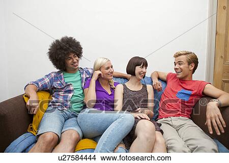 Portrait of flatmates reclining on sofa View Large Photo Image Picture - Portrait of flatmates reclining on sofa. Fotosearch