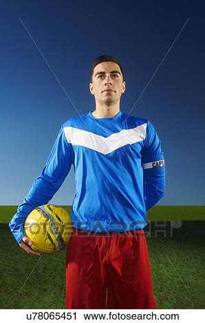 Portrait of football team captain holding ball View Large Photo Image Stock Image - Portrait of football team captain holding ball. Fotosearch