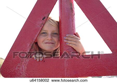 Portrait of girl looking through red triangle, Wales, UK View Large Photo Image Stock Image - Portrait of girl looking through red triangle, Wales, UK. Fotosearch