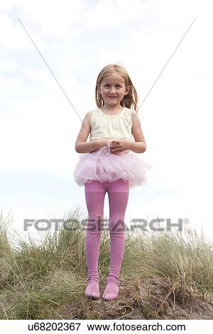 Portrait of girl wearing tutu on dunes, Wales, UK View Large Photo Image Stock Photo - Portrait of girl wearing tutu on dunes, Wales, UK. Fotosearch