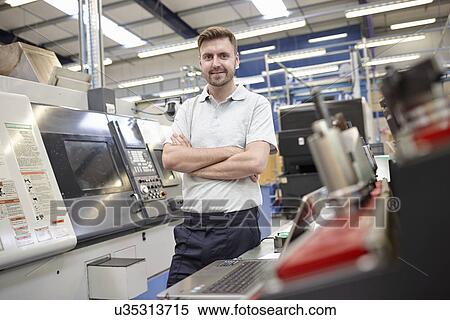 Stock Photography - Portrait of male worker in engineering factory. Fotosearch
