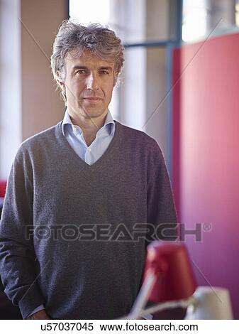 Portrait of mature businessman wearing grey jumper View Large Photo Image Stock Photography - Portrait of mature businessman wearing grey jumper. Fotosearch