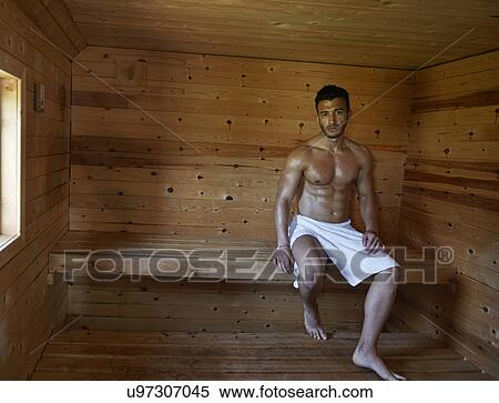 Stock Photography - Portrait of muscular young man in sauna. Fotosearch