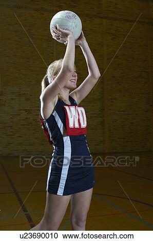 Portrait of netball player holding ball View Large Photo Image Stock Image - Portrait of netball player holding ball. Fotosearch