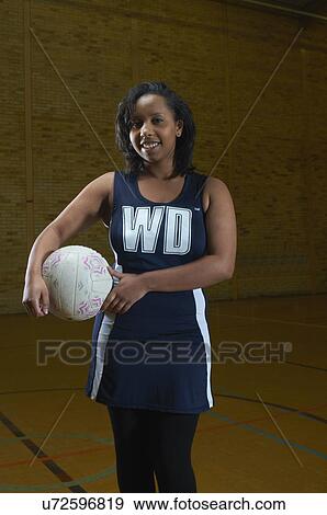 Portrait of netball player holding ball View Large Photo Image Stock Photo - Portrait of netball player holding ball. Fotosearch