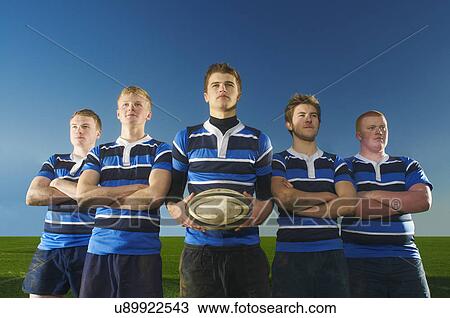 Portrait of rugby team, one man holding ball View Large Photo Image Stock Image - Portrait of rugby team, one man holding ball. Fotosearch