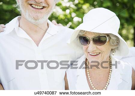 Portrait of senior woman wearing sunglasses and white sunhat View Large Photo Image Stock Photo - Portrait of senior woman wearing sunglasses and white sunhat. Fotosearch