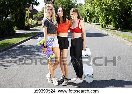 Portrait of three young women with skateboards View Large Photo Image Picture - Portrait of three young women with skateboards. Fotosearch
