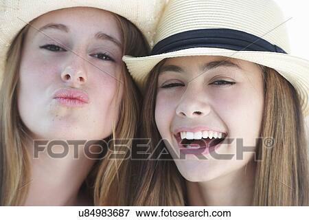 Stock Photo - Portrait of two teenage girls wearing hats. Fotosearch