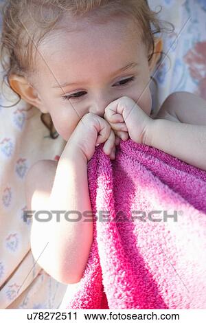Portrait of young girl holding pink towel View Large Photo Image Stock Image - Portrait of young girl holding pink towel. Fotosearch