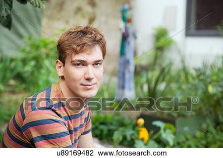 Portrait of young man looking at camera View Large Photo Image Stock Image - Portrait of young man looking at camera. Fotosearch