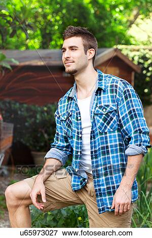 Portrait of young man wearing blue checked shirt View Large Photo Image Stock Photo - Portrait of young man wearing blue checked shirt. Fotosearch