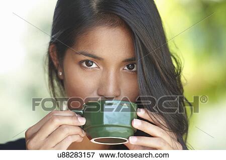 Portrait of young woman drinking coffee View Large Photo Image Stock Photo - Portrait of young woman drinking coffee. Fotosearch