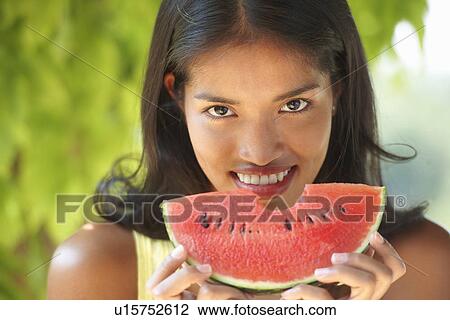Portrait of young woman eating watermelon View Large Photo Image Stock Image - Portrait of young woman eating watermelon. Fotosearch