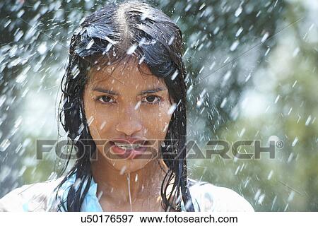 Portrait of young woman in rain View Large Photo Image Stock Photo - Portrait of young woman in rain. Fotosearch