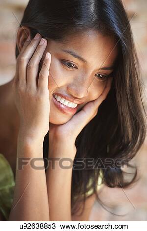 Portrait of young woman touching face View Large Photo Image Stock Image - Portrait of young woman touching face. Fotosearch