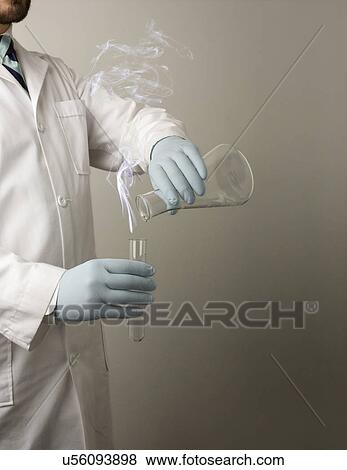 Scientist experimenting with liquid chemicals and test tube View Large Photo Image Stock Photo - Scientist experimenting with liquid chemicals and test tube. Fotosearch