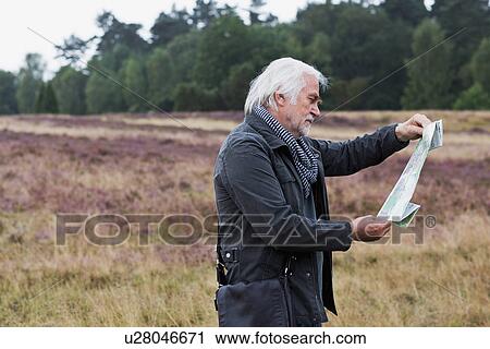 Senior man looking at map View Large Photo Image Stock Image - Senior man looking at map. Fotosearch