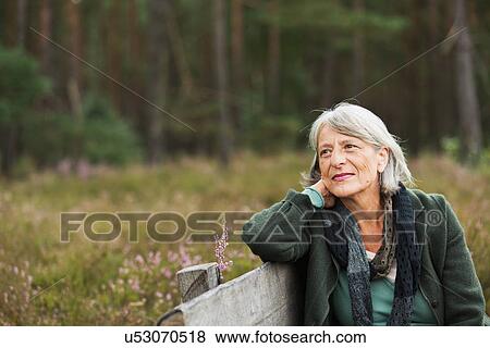 Senior woman on bench looking away View Large Photo Image Stock Photo - Senior woman on bench looking away. Fotosearch