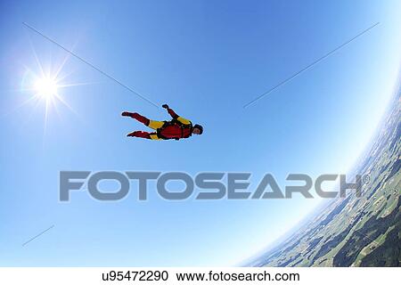 Stock Image - Skydiver free falling face down above Leutkirch, Bavaria, Germany. Fotosearch