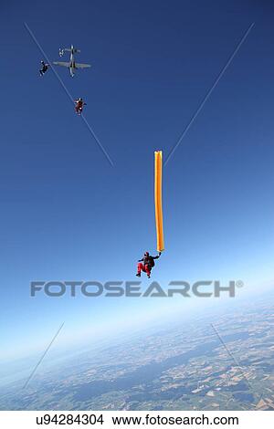 Skydivers free falling with air tube above Leutkirch, Bavaria, Germany View Large Photo Image Picture - Skydivers free falling with air tube above Leutkirch, Bavaria, Germany. Fotosearch