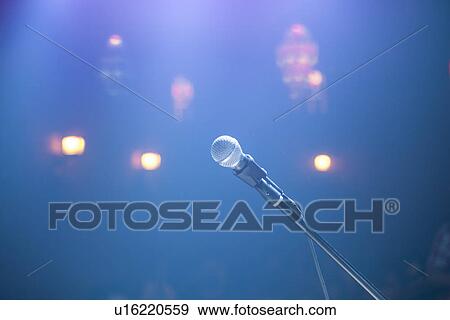 Stock Photo - Solitary microphone and spotlights in smoky nightclub. Fotosearch