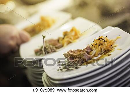 Stock Photo - Stacks of plates with starters. Fotosearch