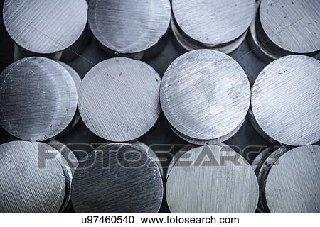 Stock Image - Stacks of raw and unworked steel discs in factory, overhead view. Fotosearch