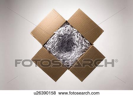 Stock Photo - Still life with open cardboard box and shredded paper. Fotosearch