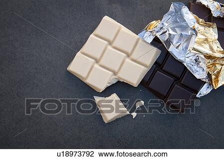 Stock Image - Still life with white and dark chocolate. Fotosearch