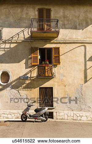 Street scene with parked scooter, Miasino, Italy View Large Photo Image Stock Image - Street scene with parked scooter, Miasino, Italy. Fotosearch