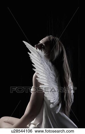 Studio portrait of graceful woman wearing angel wings View Large Photo Image Stock Photograph - Studio portrait of graceful woman wearing angel wings. Fotosearch